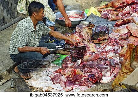 Indian Man cutting meat at the Hornbill Festival, Kohima, Nagaland, India, Asia View Large Photo Image Stock Photography - Indian Man cutting meat at the Hornbill Festival, Kohima, Nagaland, India, Asia. Fotosearch