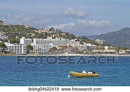 Stock Photo - Inflatable boat anchoring in front of the coast, Santa Ponca, Majorca, Spain, Europe. Fotosearch