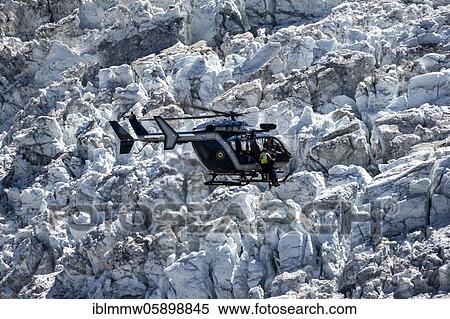 Injured person on rope, helicopter flying over glacier, Glacier de Bossons, alpine rescue, mountain rescue, Chamonix, Haute-Savoie, France, Europe View Large Photo Image Stock Photography - Injured person on rope, helicopter flying over glacier, Glacier de Bossons, alpine rescue, mountain rescue, Chamonix, Haute-Savoie, France, Europe. Fotosearch