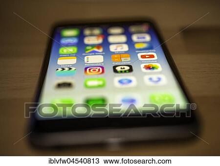IPhone lying on table, luminous display, screen, iPhone, many different app icons, app, cell phone, smartphone, iOS, macro shot, detail, full frame View Large Photo Image Stock Image - IPhone lying on table, luminous display, screen, iPhone, many different app icons, app, cell phone, smartphone, iOS, macro shot, detail, full frame. Fotosearch