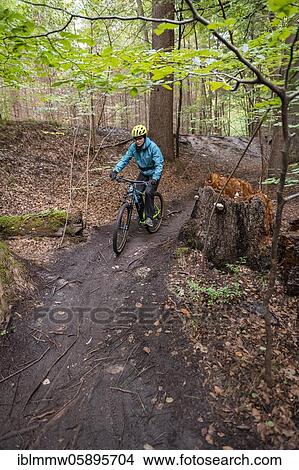 Isartrail, mountain bike trail in the forest, mountain bikers on a narrow trail, Isarauen, Munich, Upper Bavaria, Bavaria, Germany, Europe View Large Photo Image Picture - Isartrail, mountain bike trail in the forest, mountain bikers on a narrow trail, Isarauen, Munich, Upper Bavaria, Bavaria, Germany, Europe. Fotosearch