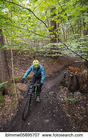 Stock Photo - Isartrail, mountain bike trail in the forest, mountain bikers on a narrow trail, Isarauen, Munich, Upper Bavaria, Bavaria, Germany, Europe. Fotosearch