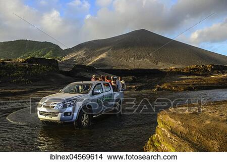 Picture - Jeep crosses river below volcano Yasur, Tanna Island, Vanuatu, South Sea, Oceania. Fotosearch