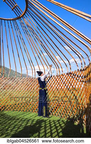 Stock Image - Kazakh men putting up a yurt, Sati village, Tien Shan Mountains, Kazakhstan, Asia. Fotosearch