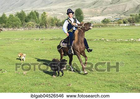 Stock Photograph - Kazakh rider in traditional clothes, Sati village, Tien Shan Mountains, Kazakhstan, Asia. Fotosearch