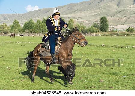 Kazakh rider in traditional clothes, Sati village, Tien Shan Mountains, Kazakhstan, Asia View Large Photo Image Stock Photography - Kazakh rider in traditional clothes, Sati village, Tien Shan Mountains, Kazakhstan, Asia. Fotosearch