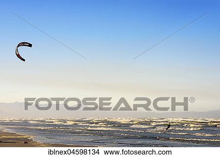 Picture - Kitesurfers at high waves, near Muizenberg, False Bay, Western Cape, South Africa, Africa. Fotosearch