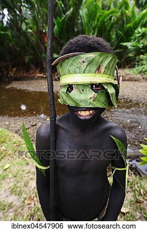 Stock Photograph - Korafe-child with facial and headdress made of leaves, McLaren-Harbour, Tufi, Papua New Guinea, Oceania. Fotosearch
