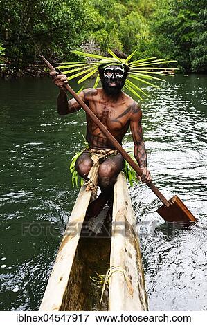 Stock Photo - Korafe-Man paddling in a dugout boat, McLaren-Harbour, Tufi, Papua New Guinea, Oceania. Fotosearch