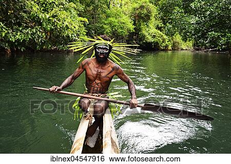 Korafe-Man paddling in a dugout boat, McLaren-Harbour, Tufi, Papua New Guinea, Oceania View Large Photo Image Stock Photograph - Korafe-Man paddling in a dugout boat, McLaren-Harbour, Tufi, Papua New Guinea, Oceania. Fotosearch