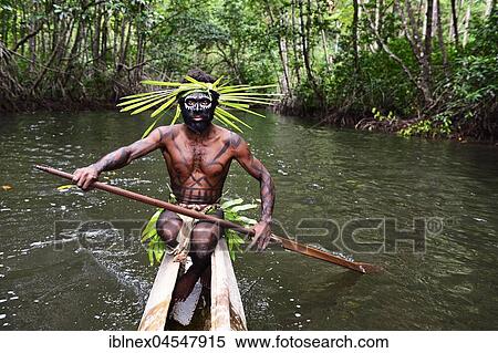 Stock Photography - Korafe-Man paddling in a dugout boat, McLaren-Harbour, Tufi, Papua New Guinea, Oceania. Fotosearch