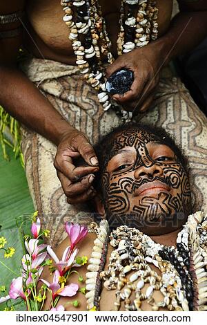 Stock Image - Korafe tribe, girl is traditionally tattooed on the face, Tufi, Papua New Guinea, Oceania. Fotosearch