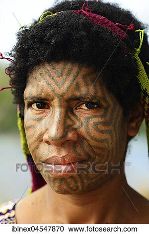 Stock Image - Korafe woman with face tattoo, portrait, Tufi, Papua New Guinea, Oceania. Fotosearch