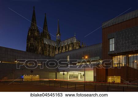 Stock Image - Kurt Hackenberg Platz with Roman-Germanic Museum, Cologne Cathedral, Filmforum and Museum Ludwig, UNESCO World Heritage Site, Dusk, Cologne, North Rhine-Westphalia, Germany, Europe. Fotosearch