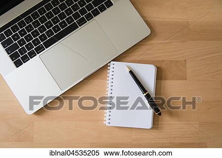 Laptop, Apple MacBook Pro with pen and notepad on desk View Large Photo Image Stock Photography - Laptop, Apple MacBook Pro with pen and notepad on desk. Fotosearch