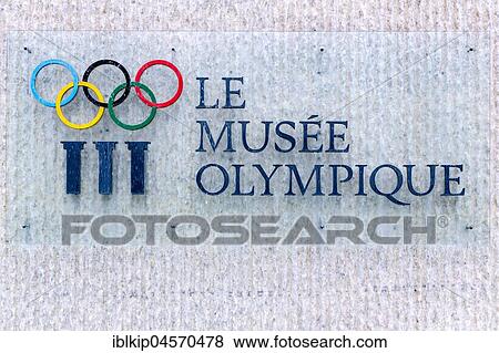 Stock Photo - Le Musee Olympique, Olympic Museum, sign at fountain with water streams across the Olympic rings, Lausanne, Switzerland, Europe. Fotosearch