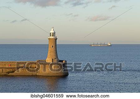 Lighthouse, cargo ship at sea, Tynemouth, Northumberland, Great Britain View Large Photo Image Stock Photo - Lighthouse, cargo ship at sea, Tynemouth, Northumberland, Great Britain. Fotosearch