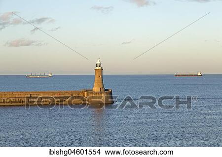 Lighthouse, cargo ships at sea, Tynemouth, Northumberland, Great Britain View Large Photo Image Picture - Lighthouse, cargo ships at sea, Tynemouth, Northumberland, Great Britain. Fotosearch