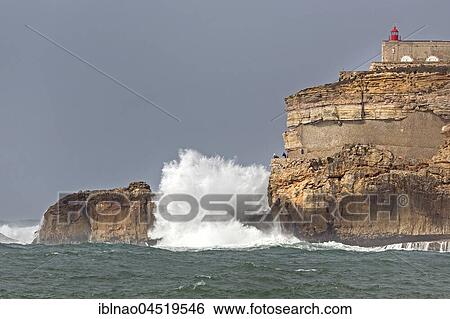 Stock Photograph - Lighthouse Farol de Nazare, high waves, Nazare, Portugal, Europe. Fotosearch