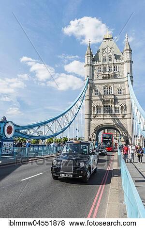Stock Photo - London taxi crosses Tower Bridge, London, England, United Kingdom, Europe. Fotosearch