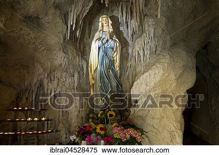 Lourdes grotto with a statue of the Virgin Mary, reconstruction of the grotto of Massabielle near Lourdes, parish church of St. John Baptist, Pfaffenhofen, Oberbayern, Bavaria, Germany, Europe View Large Photo Image Stock Photography - Lourdes grotto with a statue of the Virgin Mary, reconstruction of the grotto of Massabielle near Lourdes, parish church of St. John Baptist, Pfaffenhofen, Oberbayern, Bavaria, Germany, Europe. Fotosearch