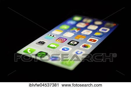 Stock Image - Luminous display, screen, iPhone, many different app icons, app, cell phone, smartphone, iOS, macro shot, detail, full frame. Fotosearch