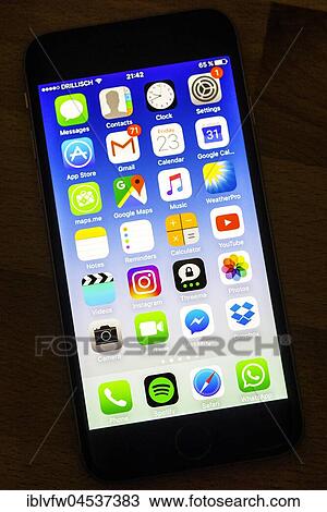 Stock Image - Luminous display, screen, iPhone, many different app icons, app, cell phone, smartphone, iOS, macro shot, detail, full frame. Fotosearch