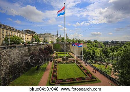 Luxembourg national flag in the park at the Place de la Constitution, Luxembourg city, Grand Duchy of Luxembourg View Large Photo Image Stock Photo - Luxembourg national flag in the park at the Place de la Constitution, Luxembourg city, Grand Duchy of Luxembourg. Fotosearch