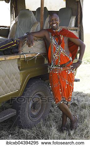 Maasai man, 28 years, in traditional shuka, leaning on safari vehicle, Mara Triangle, Masai Mara, Narok County, Kenya, Africa View Large Photo Image Stock Photography - Maasai man, 28 years, in traditional shuka, leaning on safari vehicle, Mara Triangle, Masai Mara, Narok County, Kenya, Africa. Fotosearch