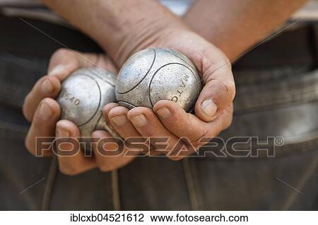 Male hands holding Petanque balls, Sanary-sur-Mer, Var department, France, Europe View Large Photo Image Stock Image - Male hands holding Petanque balls, Sanary-sur-Mer, Var department, France, Europe. Fotosearch