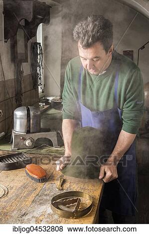 Stock Photo - Man fitting wet hat body to wooden form, hatmaker workshop, Bad Aussee, Styria, Austria, Europe. Fotosearch