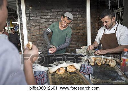 Man forms pasta with meat filling and deep-fries it, street sale, snack bar, central market in Dushanbe, Tajikistan, Asia View Large Photo Image Stock Image - Man forms pasta with meat filling and deep-fries it, street sale, snack bar, central market in Dushanbe, Tajikistan, Asia. Fotosearch