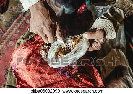 Man scrapes opium with a knife from a plastic bag, Bozai Gumbaz, Wakhan Corridor, Badakhshan, Afghanistan, Asia View Large Photo Image Stock Image - Man scrapes opium with a knife from a plastic bag, Bozai Gumbaz, Wakhan Corridor, Badakhshan, Afghanistan, Asia. Fotosearch