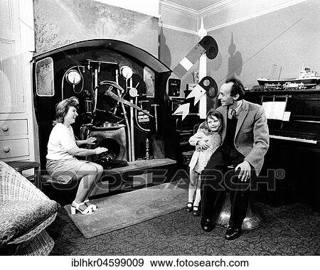 Man woman and child sitting in front of strange machine, England, Great Britain View Large Photo Image Stock Photo - Man woman and child sitting in front of strange machine, England, Great Britain. Fotosearch
