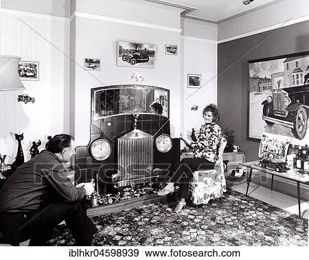 Married couple sitting in apartment with car decoration, England, Great Britain View Large Photo Image Stock Photo - Married couple sitting in apartment with car decoration, England, Great Britain. Fotosearch