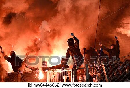 Masked football fans rampage, throwing flares, pyrotechnics, firecrackers, Mercedes-Benz Arena, Stuttgart, Baden-Württemberg, Germany, Europe View Large Photo Image Stock Image - Masked football fans rampage, throwing flares, pyrotechnics, firecrackers, Mercedes-Benz Arena, Stuttgart, Baden-Württemberg, Germany, Europe. Fotosearch