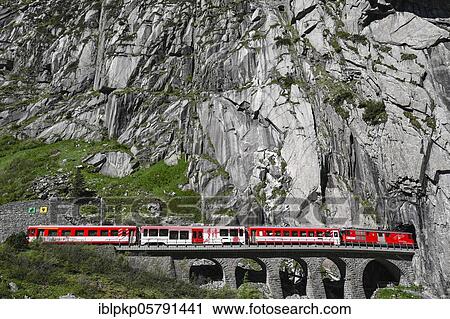 Stock Image - Matterhorn Gotthard Bahn on a stone bridge, exit Urnerloch, Switzerland, Europe. Fotosearch