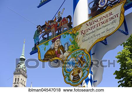 Stock Photo - Maypole at the Viktualienmarkt, church tower Alter Peter, old town, Munich, Upper Bavaria, Bavaria, Germany, Europe. Fotosearch