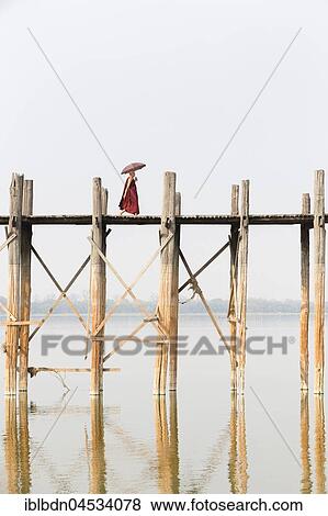 Stock Photo - Monk crossing U Bein bridge, Taungthaman Lake, Mandalay region, Myanmar, Asia. Fotosearch