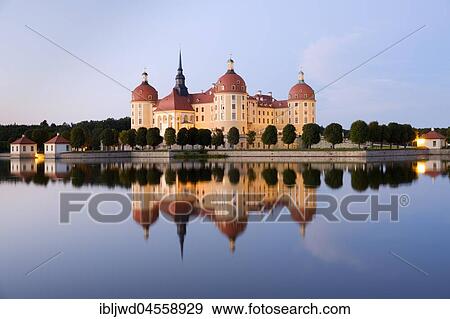 Stock Photo - Moritzburg castle with reflection in lake, blue hour, Saxony, Germany, Europe. Fotosearch