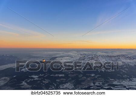 Morning light, sunrise during a balloon ride, view of the Alps, position about 5400 m above sea level, over Neukirchen am Großvenediger, Viewing direction Westendorf and Kitzbühel, Austria, Europe View Large Photo Image Stock Photography - Morning light, sunrise during a balloon ride, view of the Alps, position about 5400 m above sea level, over Neukirchen am Großvenediger, Viewing direction Westendorf and Kitzbühel, Austria, Europe. Fotosearch