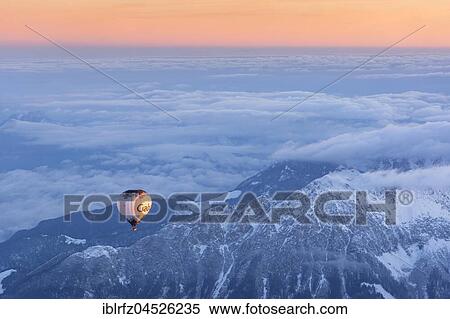 Stock Photography - Morning light, sunrise during a balloon ride, view of the Alps, position about 5400 m above sea level, over Neukirchen am Großvenediger, Viewing direction Westendorf and Kitzbühel, Austria, Europe. Fotosearch