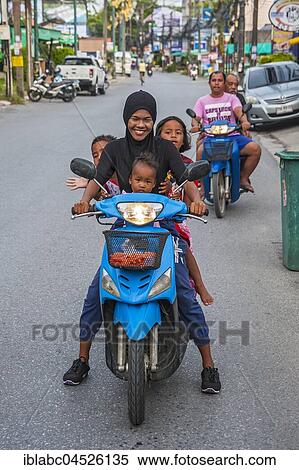Mother with three children on scooter, Chalong Bay, Phuket, Thailand, Asia View Large Photo Image Stock Photography - Mother with three children on scooter, Chalong Bay, Phuket, Thailand, Asia. Fotosearch