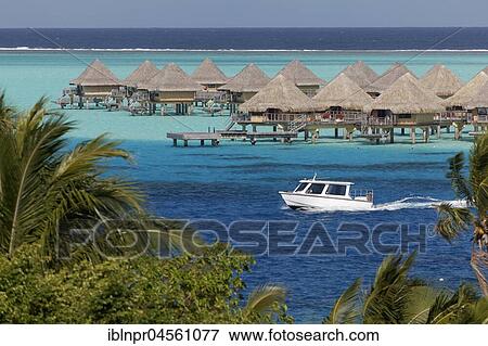 Stock Photo - Motorboat, bungalows in the turquoise sea, resort Sofitel Bora Bora, island Bora Bora, society islands, French Polynesia, Oceania. Fotosearch