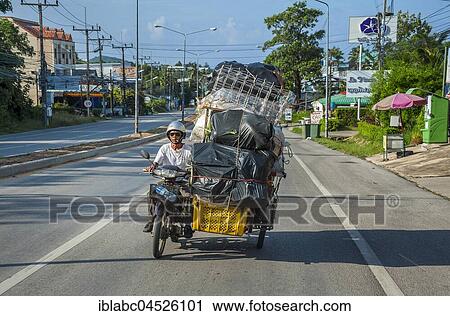 Stock Image - Motorcycle with heavily loaded side car, Phuket, Thailand, Asia. Fotosearch
