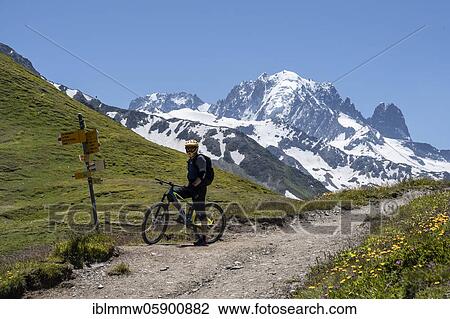 Stock Image - Mountain bikers at Col de Balme, in the back Aiguille Verte, glacier and mountain tops, Chamonix, Haute-Savoie, France, Europe. Fotosearch