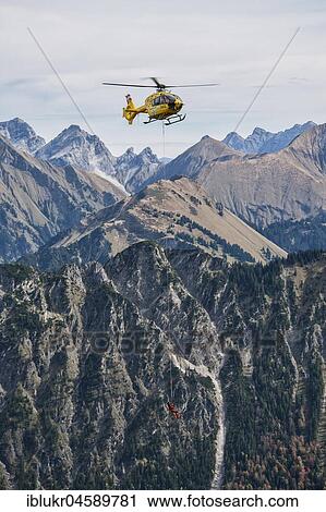 Stock Image - Mountain rescue by helicopter on the Fellhorn ridge, Kleinwalsertal, Riezlern, Vorarlberg, Austria, Europe. Fotosearch