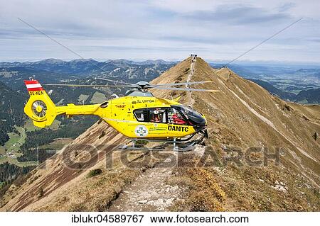 Stock Photo - Mountain rescue by helicopter on the Fellhorn ridge, Kleinwalsertal, Riezlern, Vorarlberg, Austria, Europe. Fotosearch