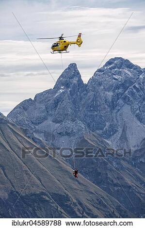 Stock Photo - Mountain rescue by helicopter on the Fellhorn ridge, Kleinwalsertal, Riezlern, Vorarlberg, Austria, Europe. Fotosearch