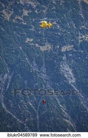 Stock Photo - Mountain rescue by helicopter on the Fellhorn ridge, Kleinwalsertal, Riezlern, Vorarlberg, Austria, Europe. Fotosearch